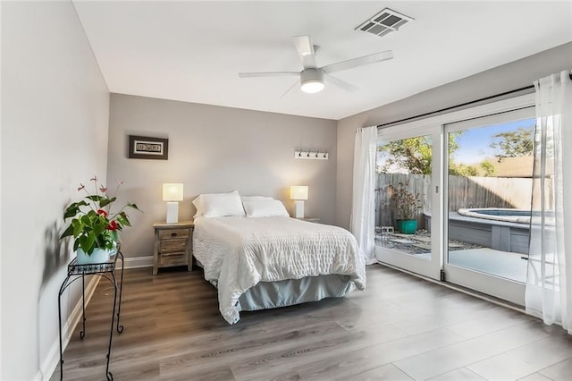 bedroom featuring access to outside, ceiling fan, and wood-type flooring