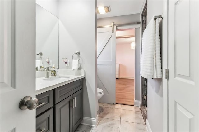 bathroom featuring toilet, vanity, and tile patterned floors