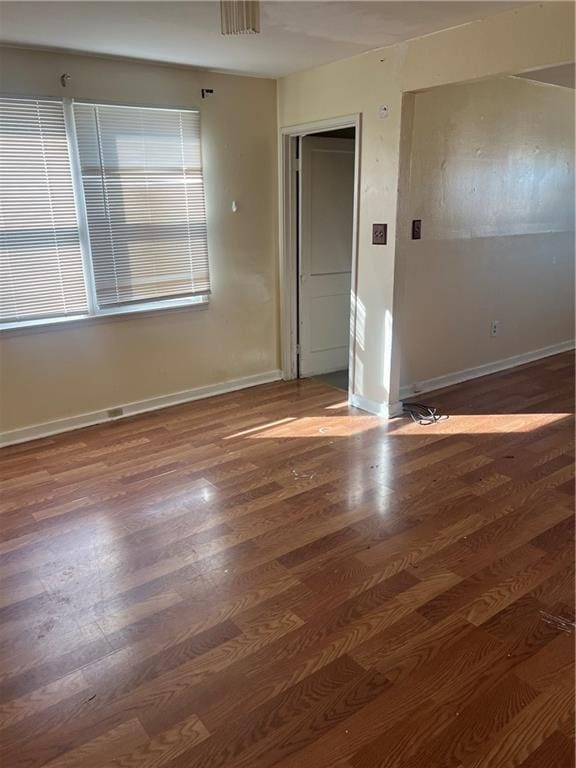 empty room with dark wood-type flooring