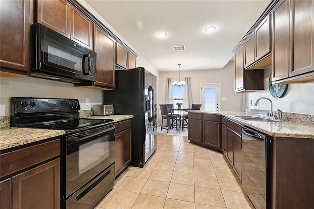 kitchen with sink, hanging light fixtures, a notable chandelier, light tile patterned flooring, and black appliances