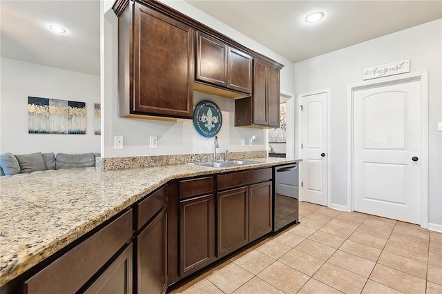 kitchen with sink, light stone countertops, dishwashing machine, light tile patterned flooring, and dark brown cabinets