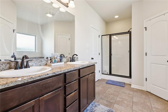 bathroom featuring tile patterned flooring, vanity, and walk in shower