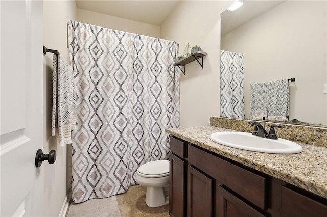 bathroom with tile patterned floors, vanity, and toilet