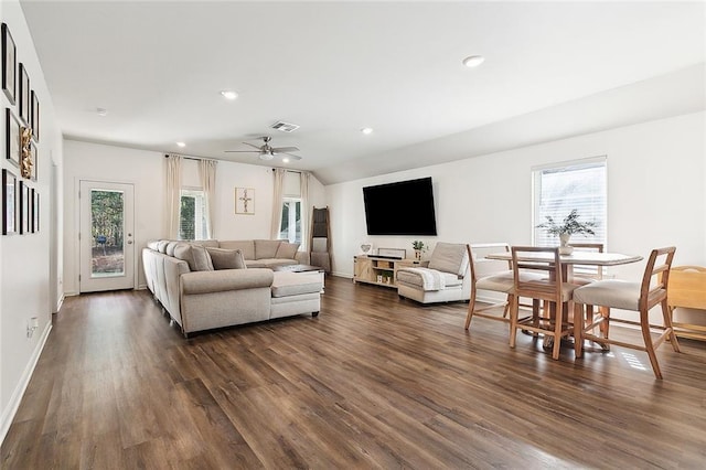 living room featuring ceiling fan, vaulted ceiling, and dark hardwood / wood-style floors