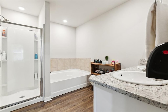 bathroom featuring separate shower and tub, vanity, and hardwood / wood-style flooring