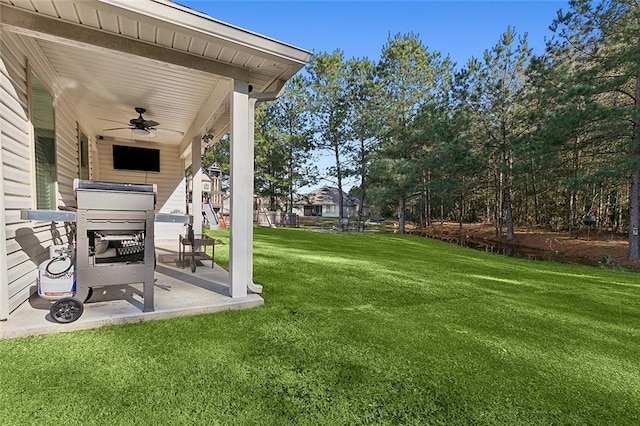 view of yard featuring ceiling fan and a patio