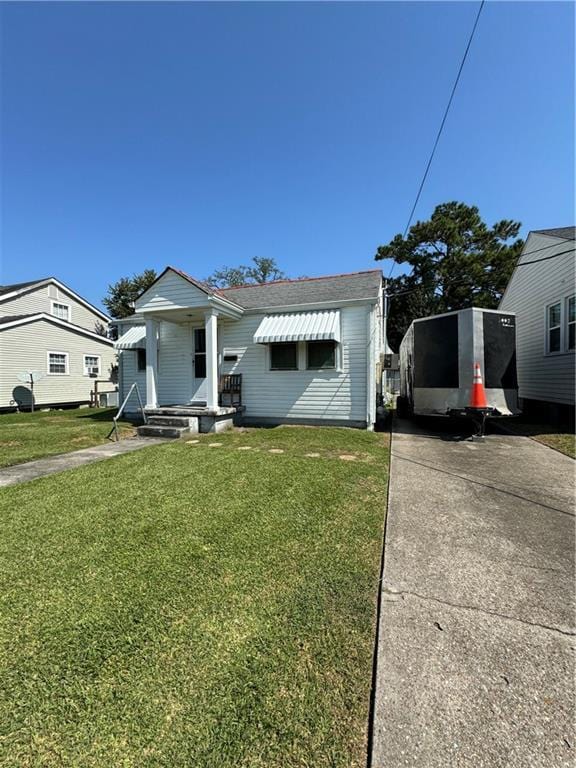 bungalow-style home with a front yard