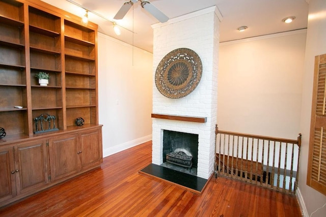 living room with ceiling fan, dark hardwood / wood-style flooring, and a fireplace