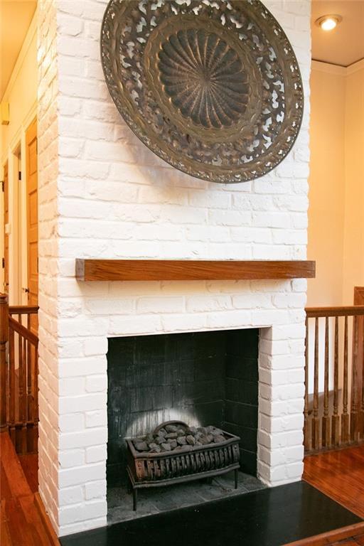 details featuring hardwood / wood-style flooring and a fireplace