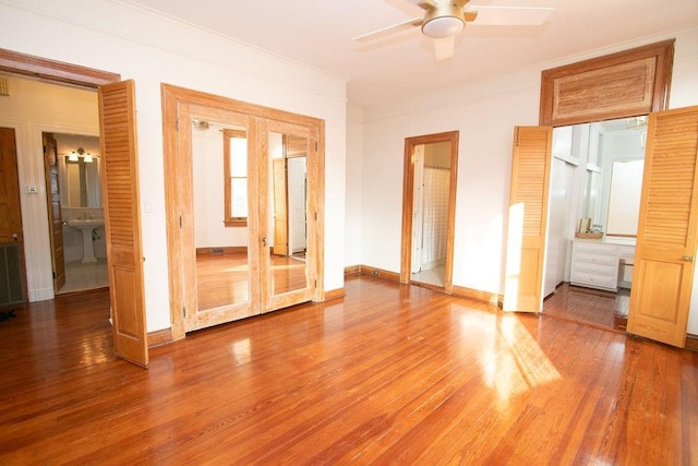 unfurnished bedroom featuring ceiling fan, connected bathroom, ornamental molding, and french doors