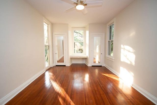 unfurnished room with ceiling fan and dark hardwood / wood-style flooring