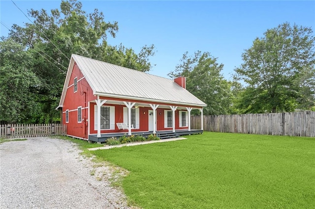 exterior space with covered porch, driveway, and fence