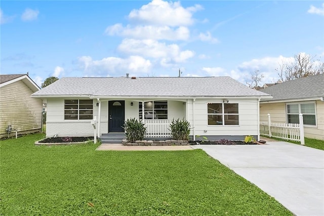 ranch-style house featuring a porch and a front lawn