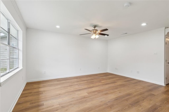 unfurnished room with light wood-type flooring and ceiling fan