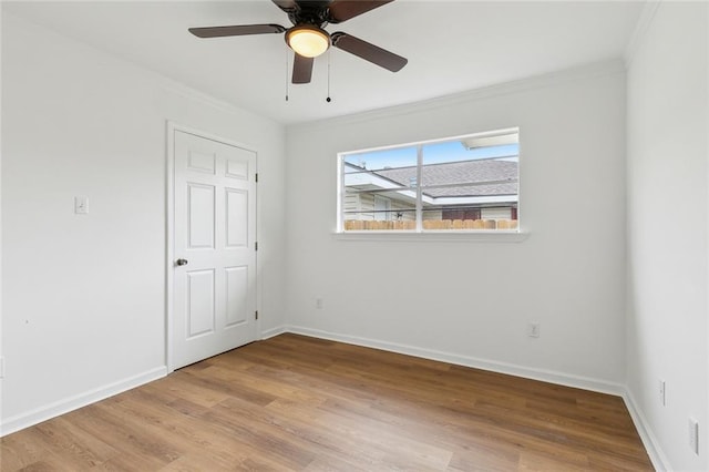 unfurnished room with light wood-type flooring, ceiling fan, and crown molding