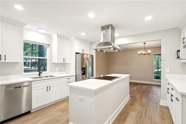 kitchen featuring sink, white cabinetry, stainless steel appliances, island exhaust hood, and a kitchen island