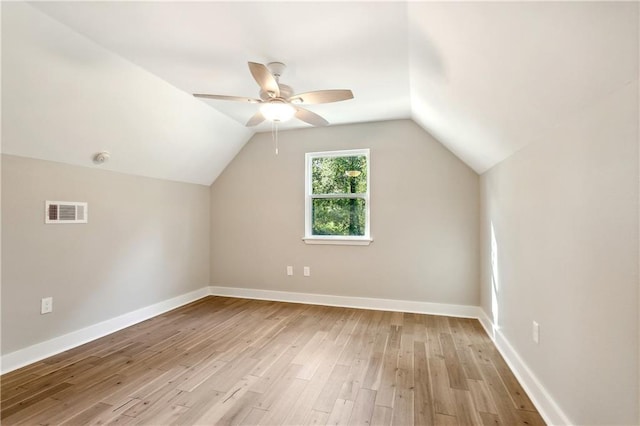 additional living space with ceiling fan, vaulted ceiling, and light wood-type flooring