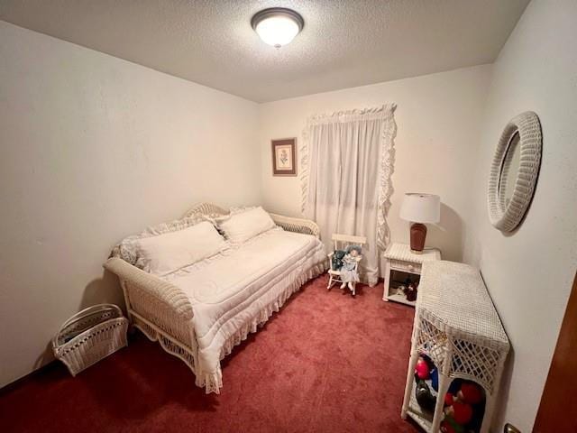 carpeted bedroom featuring a textured ceiling