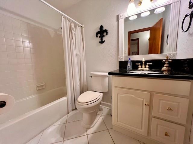 full bathroom with shower / bath combination with curtain, vanity, toilet, and tile patterned flooring