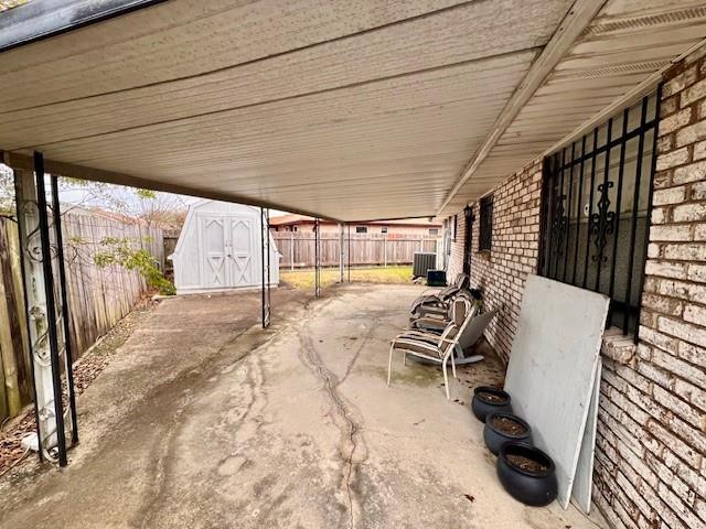 view of patio featuring a shed