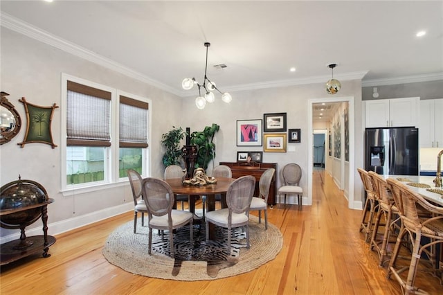 kitchen featuring a breakfast bar, a center island, sink, appliances with stainless steel finishes, and white cabinetry