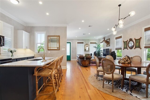 hallway featuring light hardwood / wood-style floors and ornamental molding