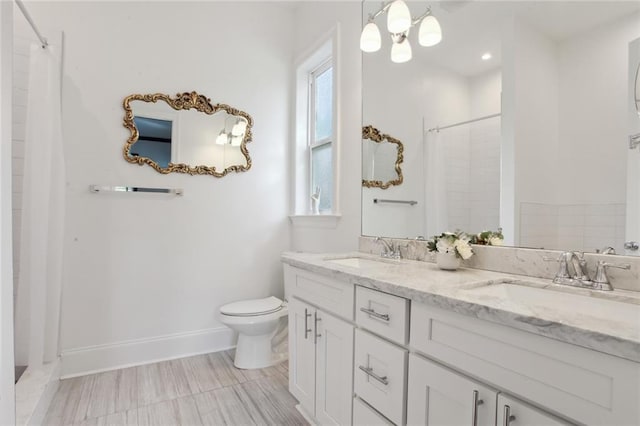 full bath featuring a shower with shower curtain, a sink, and toilet