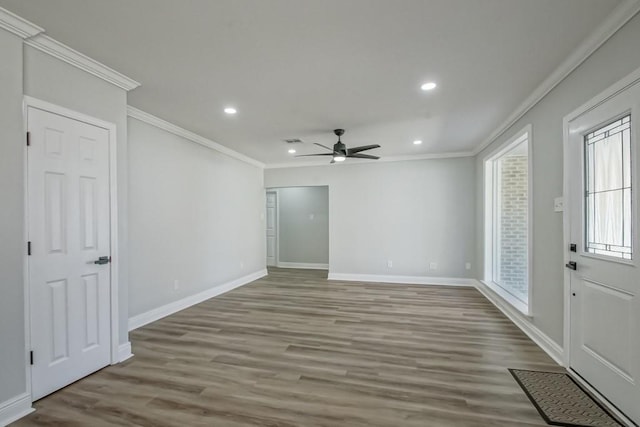 interior space featuring ceiling fan, hardwood / wood-style floors, and crown molding