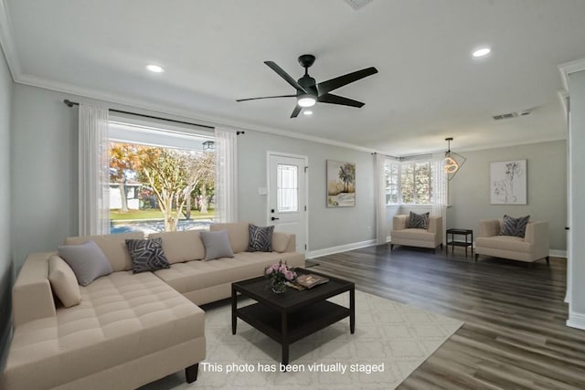 living room featuring hardwood / wood-style floors, ceiling fan, and crown molding