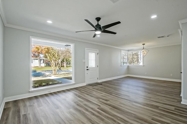 foyer entrance with ceiling fan, crown molding, a healthy amount of sunlight, and dark hardwood / wood-style floors