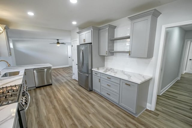 kitchen featuring gray cabinets, sink, light wood-type flooring, and appliances with stainless steel finishes