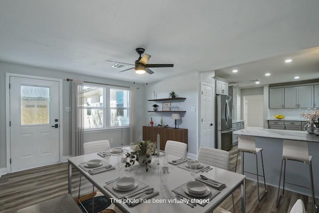 dining room featuring ceiling fan and dark wood-type flooring