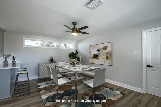 dining area with ceiling fan and dark hardwood / wood-style flooring