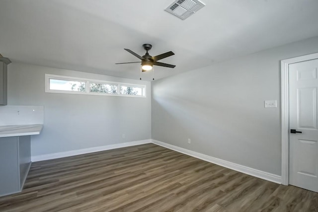 spare room featuring ceiling fan and dark hardwood / wood-style floors