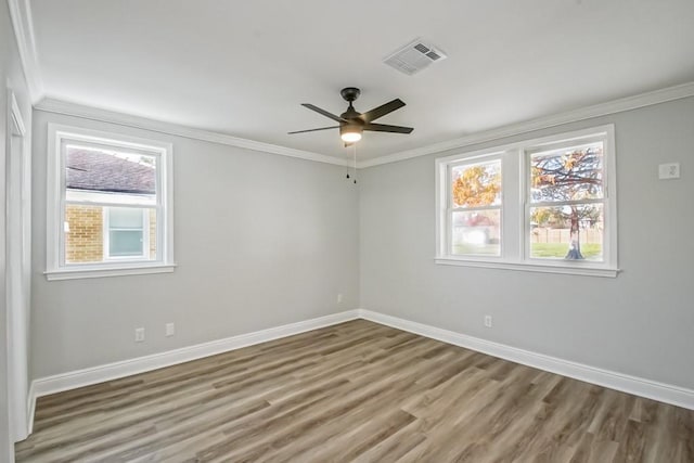 unfurnished room featuring ceiling fan, wood-type flooring, and crown molding