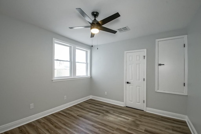 empty room featuring ceiling fan and dark hardwood / wood-style floors