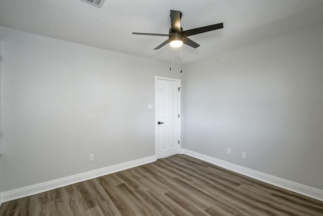 empty room featuring ceiling fan and dark hardwood / wood-style floors