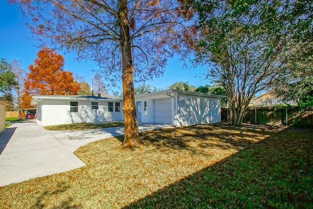 single story home featuring a garage and a front lawn