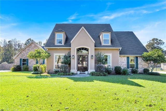 view of front of house with french doors, a front lawn, a shingled roof, and stucco siding