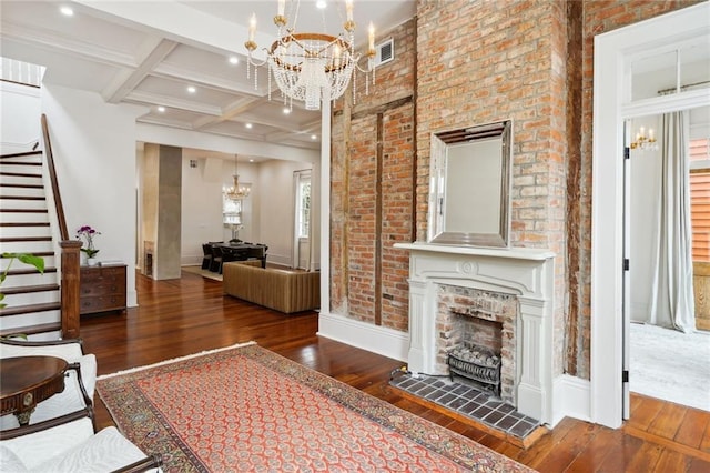 unfurnished living room with beamed ceiling, dark hardwood / wood-style flooring, a fireplace, and coffered ceiling