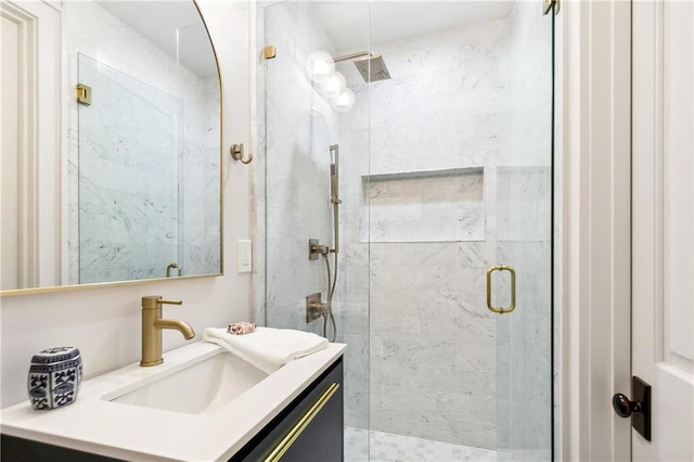 bathroom featuring vanity and a shower with door