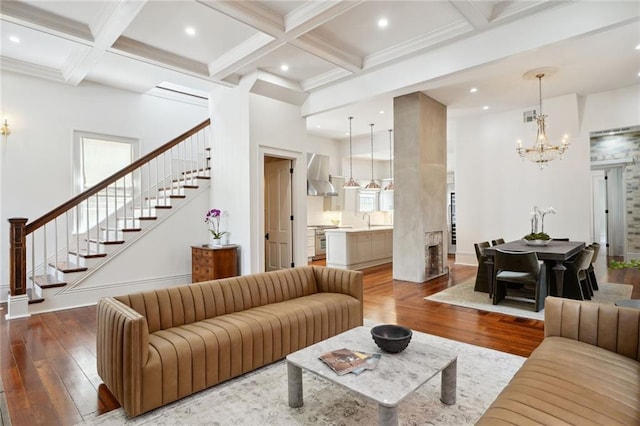 living room with beamed ceiling, coffered ceiling, and hardwood / wood-style flooring