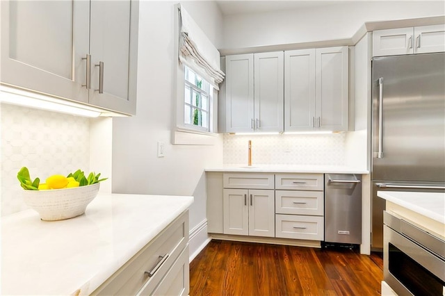 kitchen featuring decorative backsplash, high end refrigerator, and dark hardwood / wood-style floors