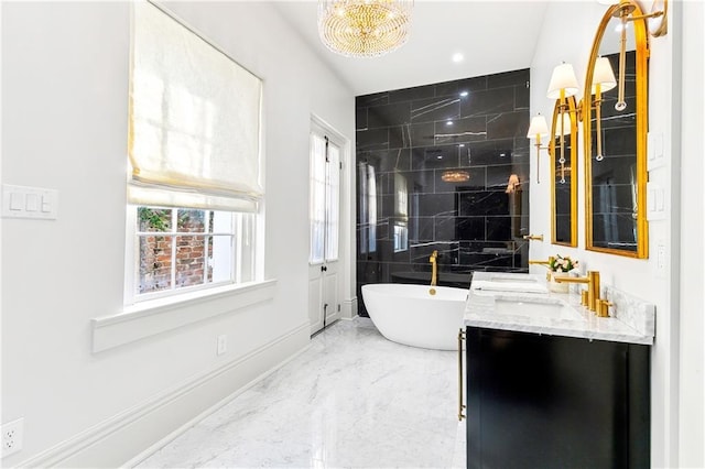 bathroom featuring a washtub, vanity, and a chandelier