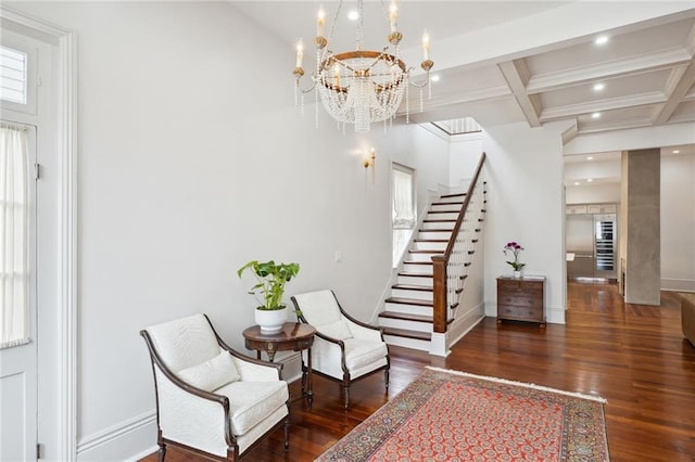 interior space with beam ceiling, a wealth of natural light, dark wood-type flooring, and an inviting chandelier