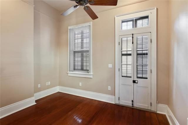 interior space with dark wood-type flooring and ceiling fan