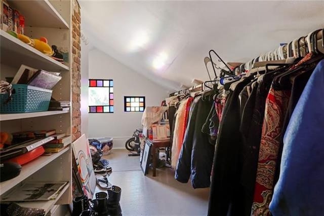 walk in closet with vaulted ceiling