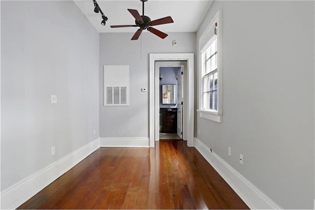 unfurnished room featuring ceiling fan, dark hardwood / wood-style floors, and track lighting