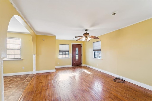 entryway featuring a wealth of natural light, ornamental molding, and ceiling fan