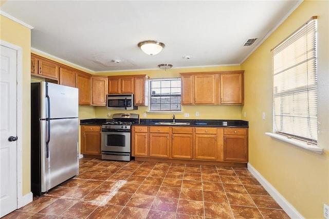 kitchen featuring sink, ornamental molding, and stainless steel appliances